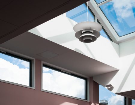 low-angle-shot-lamp-hanging-inside-building-with-glass-ceiling